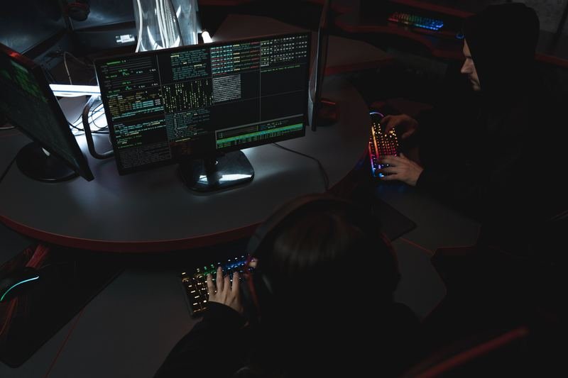 Security team monitoring systems on screens in an operations room